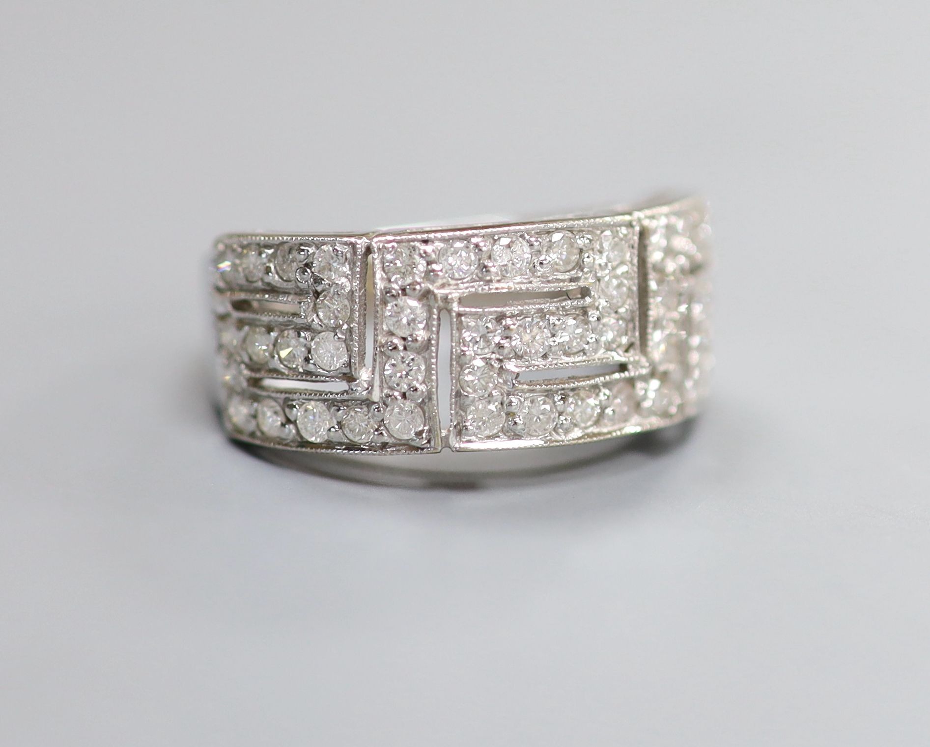 A modern 18ct white gold and diamond set 'Greek Key' dress ring, size P/Q, gross weight 5.4 grams.